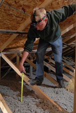 Loren-measuring-attic-insulation