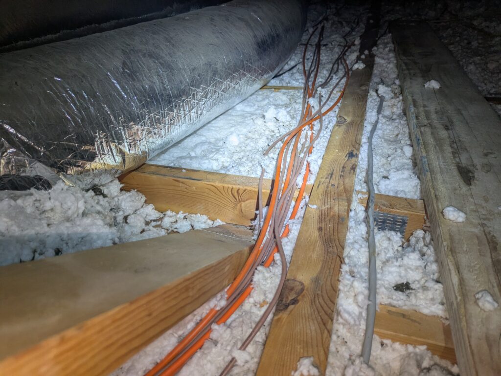 You can see the 2x6 bottom chords of trusses showing insulation that is only 1”deep in places in Julia’s attic